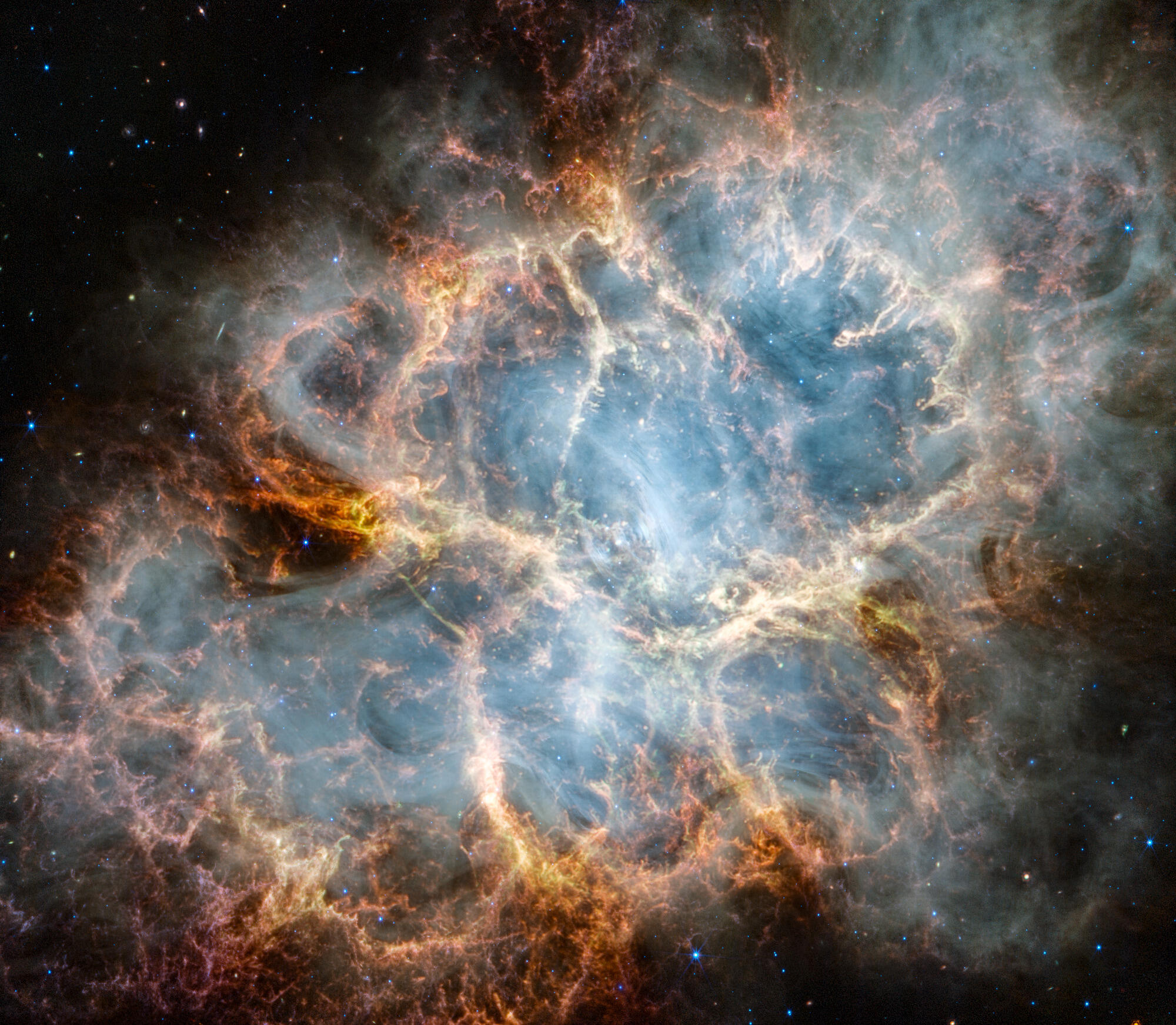 A vibrant infrared image of the Crab Nebula supernova remnant. A crisp, cage-like structure of fluffy red-orange gas filaments surrounds a ghostly, translucent white interior of synchrotron radiation. At the very center, a tiny, bright white dot marks the